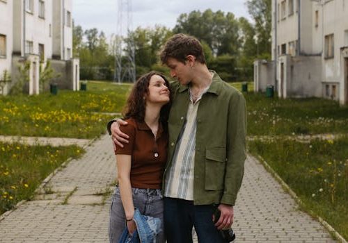 A young couple in a loving embrace on a spring day in an urban park.